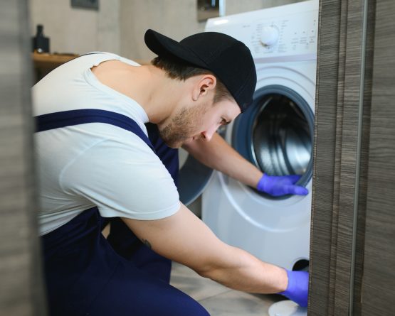 Technician repairing a washing machine