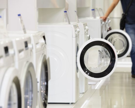 washing machines in appliance store and defocused buyer